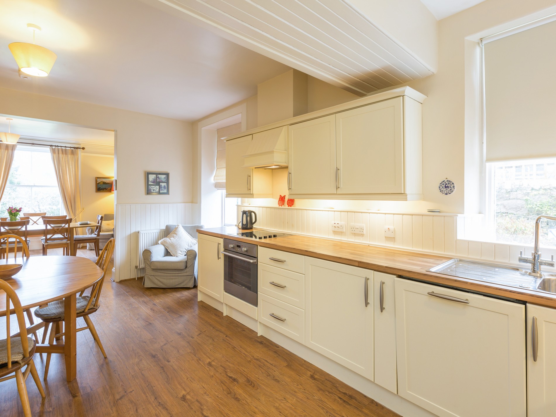 Kitchen with counters and oven looking onto dining room