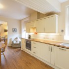 Kitchen with counters and oven looking onto dining room