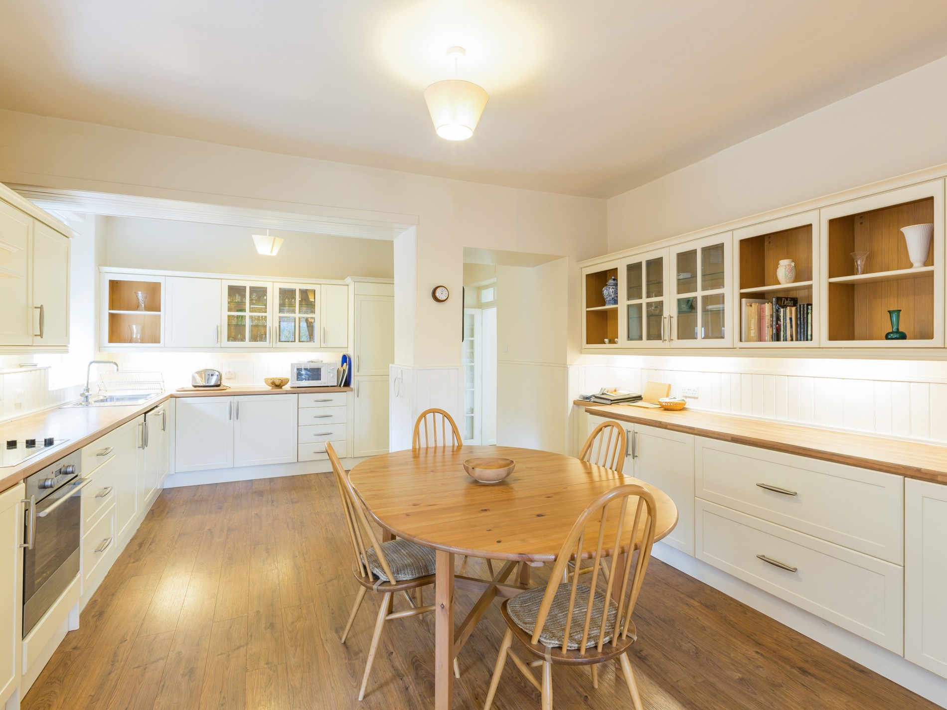 Dining room/ kitchen with small dining table, oven and kitchen counters
