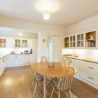 Dining room/ kitchen with small dining table, oven and kitchen counters