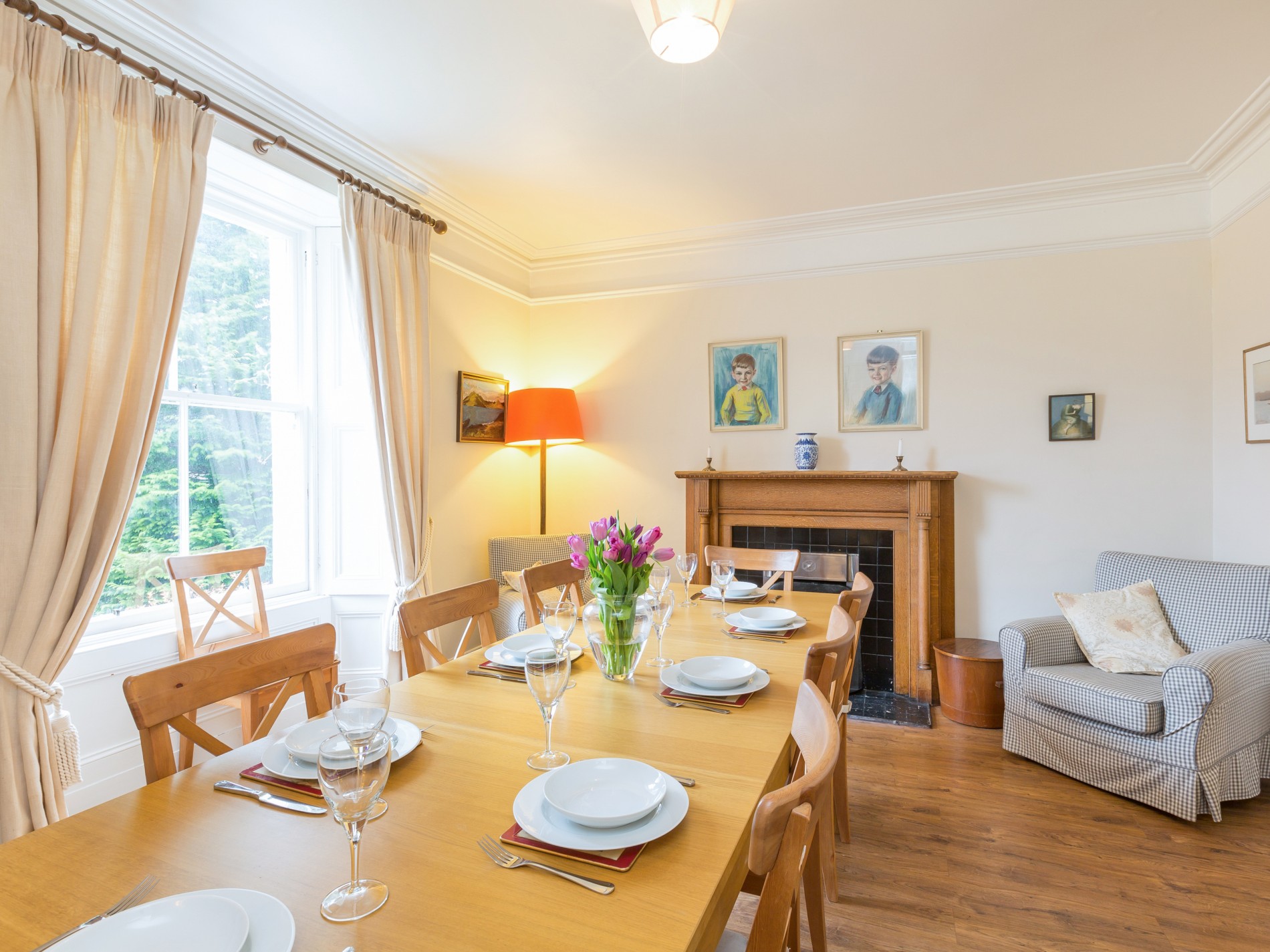 Dining room with large dining table, armchair and window