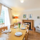 Dining room with large dining table, armchair and window