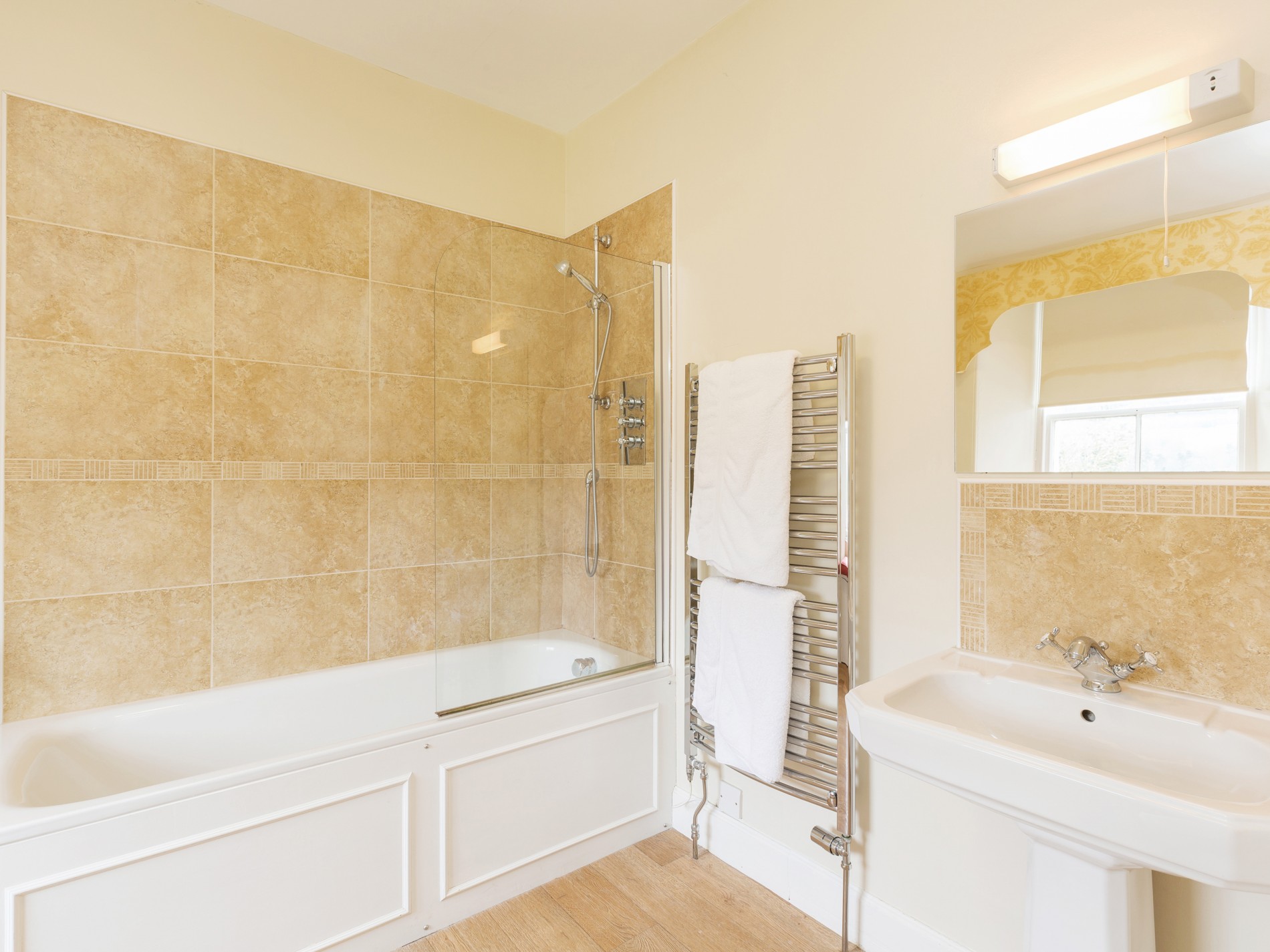 Bathroom with shower/ bath, towel radiator and sink