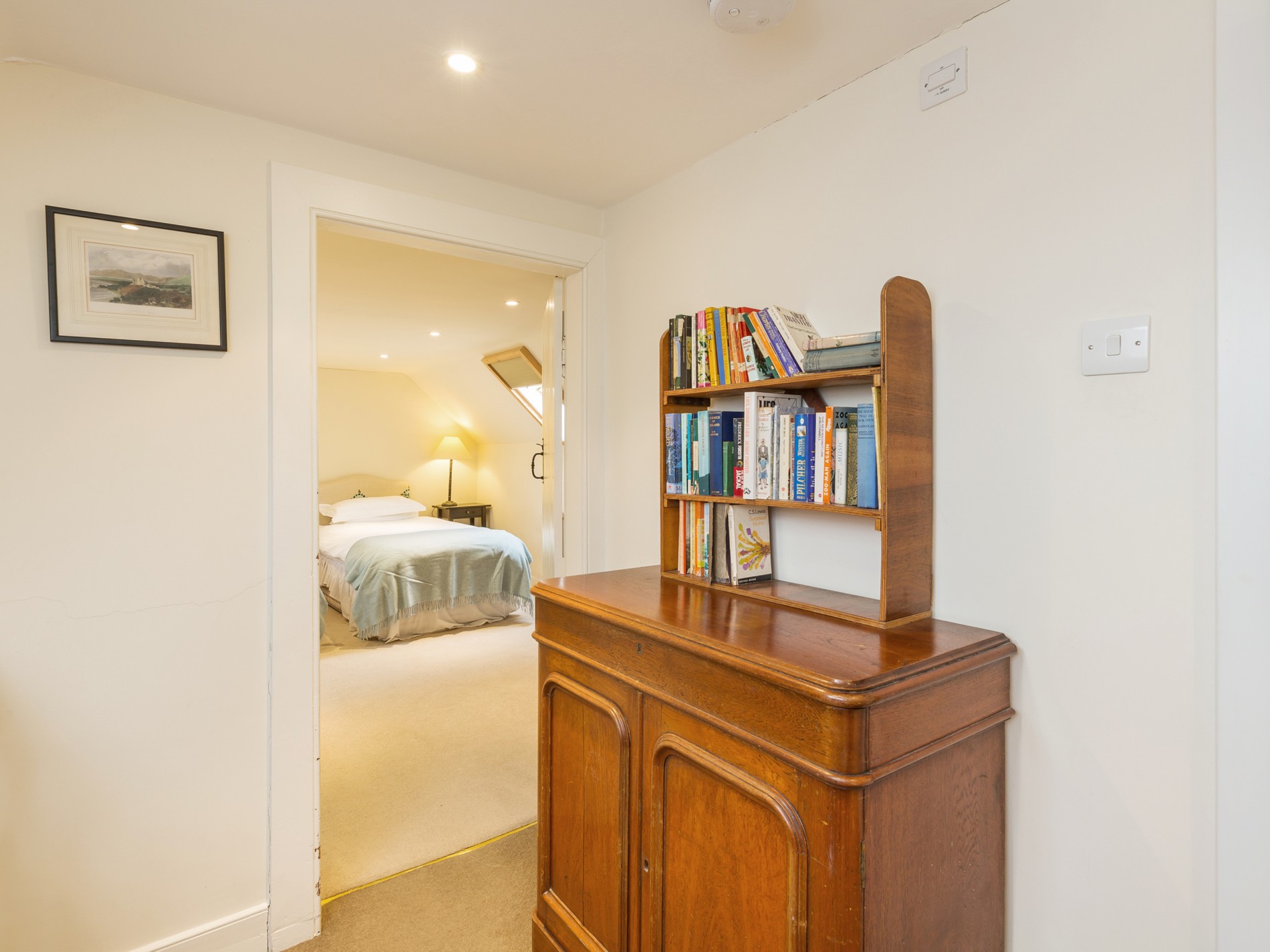 Bookshelf with cabinet looking onto bedroom