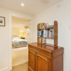 Bookshelf with cabinet looking onto bedroom