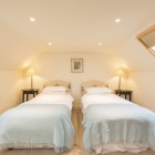 Bedroom with two single beds and bedside tables