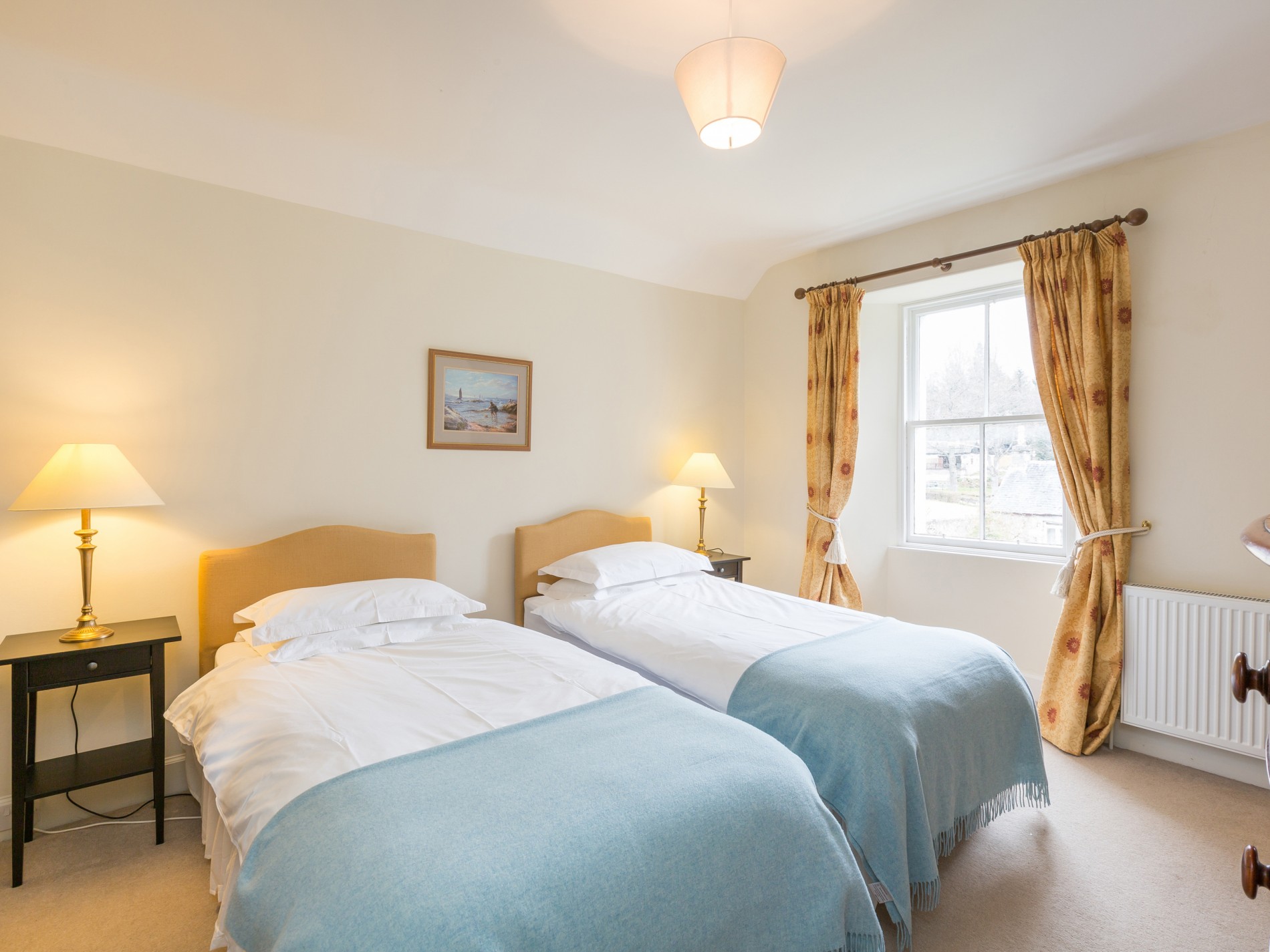 Bedroom with two single beds each with bedside tables