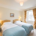 Bedroom with two single beds each with bedside tables